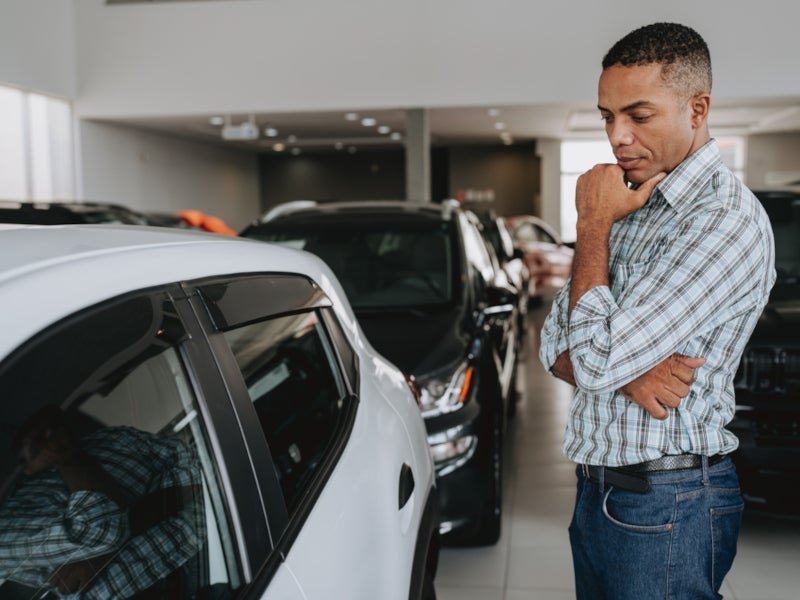 Man examining a used vehicle at Jennings Chevrolet Buick GMC